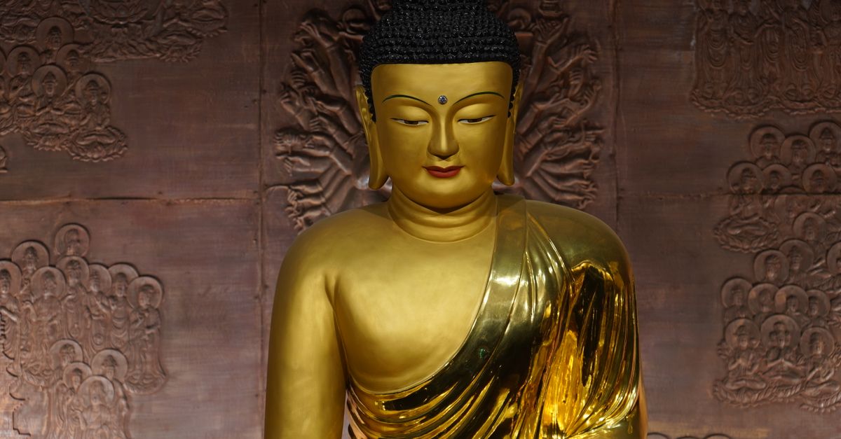A detailed view of a golden Buddha statue in a Seoul temple, highlighting Korean art and spirituality.